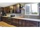 Kitchen features custom cabinets, stainless steel appliances, a view of backyard, and hardwood floors at 1664 Woodside Cir, Franklin, IN 46131