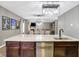 Kitchen island with stainless steel dishwasher and a view into the dining and living areas at 1664 Woodside Cir, Franklin, IN 46131