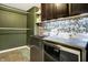 Convenient laundry room with modern washer and dryer, custom floral wallpaper and shelving at 1664 Woodside Cir, Franklin, IN 46131