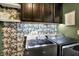 Laundry room with cabinets, open shelving, neutral walls and stainless steel washer and dryer at 1664 Woodside Cir, Franklin, IN 46131
