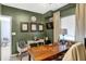 This spacious office showcases unique artwork, a comfortable chair, and an abundance of natural light at 1664 Woodside Cir, Franklin, IN 46131