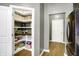 Organized walk-in pantry with custom shelving, baskets, and tile backsplash offers ample storage at 1664 Woodside Cir, Franklin, IN 46131