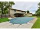 A covered in-ground pool with an adjacent covered patio and a stone fireplace in the backyard at 18906 Crestview Ct, Westfield, IN 46074