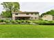 Spacious backyard featuring a well-kept lawn, landscaped garden beds, partial view of a covered patio, and a storage shed at 18906 Crestview Ct, Westfield, IN 46074