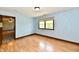 Bedroom featuring light blue walls, wood-look floors, and natural light from a window at 18906 Crestview Ct, Westfield, IN 46074