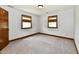 Bedroom with neutral carpet, wood trim, and natural light from two windows with blinds at 18906 Crestview Ct, Westfield, IN 46074