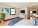 Staged bedroom featuring light walls, modern furniture, hardwood floors, and lots of natural light at 18906 Crestview Ct, Westfield, IN 46074