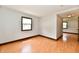 A bright bedroom with hardwood floors and a view into the hallway through the doorway at 18906 Crestview Ct, Westfield, IN 46074