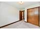 Carpeted bedroom with wood trim features a large closet and doorway to another room at 18906 Crestview Ct, Westfield, IN 46074