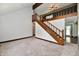 Bright living room with a staircase, neutral carpet, wooden accents, and natural light at 18906 Crestview Ct, Westfield, IN 46074