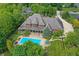 Expansive aerial view of a brick home, showcasing the backyard pool and lush green landscaping at 20170 Starlight Ct, Noblesville, IN 46062