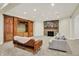 Finished basement features built-ins, a stone fireplace, neutral carpet, and comfortable furniture at 20170 Starlight Ct, Noblesville, IN 46062