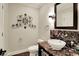 Stylish half bathroom featuring marble countertop, ornate mirror, designer light fixture and decorative wall art at 20170 Starlight Ct, Noblesville, IN 46062
