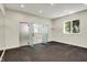 Bright bonus room features sleek black floor, neutral walls, window and open doors to another area at 20170 Starlight Ct, Noblesville, IN 46062