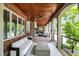 Covered patio features brick details, wood ceiling, ceiling fans and white outdoor furniture at 20170 Starlight Ct, Noblesville, IN 46062