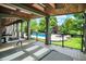 Covered patio featuring spa, ceiling fan, outdoor pool, green landscaping, and seating area at 20170 Starlight Ct, Noblesville, IN 46062