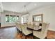 Elegant dining room with large windows, and a wooden table with upholstered chairs at 20170 Starlight Ct, Noblesville, IN 46062