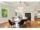 Formal dining room with hardwood floors, modern chandelier, and windows offering natural light at 20170 Starlight Ct, Noblesville, IN 46062