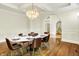 Formal dining room with hardwood floors, decorative chandelier, and wainscoting at 20170 Starlight Ct, Noblesville, IN 46062