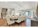 Elegant dining room with wooden table, upholstered chairs, and view to the stairs and fireplace at 20170 Starlight Ct, Noblesville, IN 46062