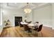 Dining room featuring modern chandelier, a fireplace, and a bar cart in an elegant setting at 20170 Starlight Ct, Noblesville, IN 46062
