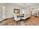 Elegant dining room with wooden table, upholstered chairs, and door access to the outside at 20170 Starlight Ct, Noblesville, IN 46062
