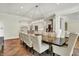 Elegant dining room with wooden table, upholstered chairs, and view to the kitchen at 20170 Starlight Ct, Noblesville, IN 46062