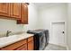 Well-equipped laundry room with modern appliances, sink, and storage cabinets at 20170 Starlight Ct, Noblesville, IN 46062