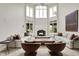 Bright living room with soaring windows, fireplace, and neutral furniture at 20170 Starlight Ct, Noblesville, IN 46062
