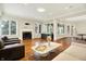 Open living area with fireplace, hardwood floors, and natural light, with windows looking out to the backyard at 20170 Starlight Ct, Noblesville, IN 46062