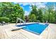 Inviting in-ground pool featuring a diving board, slide, and relaxing lounge chairs surrounded by lush landscaping at 20170 Starlight Ct, Noblesville, IN 46062