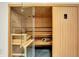 Luxury home sauna with cedar plank walls, wooden benches, and glass door at 20170 Starlight Ct, Noblesville, IN 46062