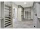 Walk-in closet with custom shelving and open doorway to bathroom and shower at 20170 Starlight Ct, Noblesville, IN 46062