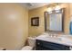 Cozy powder room with a stylish vanity featuring a marble countertop and a framed mirror at 24 Cinnamon Ct, Brownsburg, IN 46112
