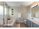 Bright bathroom with a soaking tub, glass-enclosed shower, and a gray double vanity at 24 Cinnamon Ct, Brownsburg, IN 46112