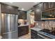 Well-equipped kitchen with stainless steel refrigerator and granite countertops at 24 Cinnamon Ct, Brownsburg, IN 46112