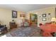 Cozy living room with hardwood floors, area rug, and access to the dining room at 24 Cinnamon Ct, Brownsburg, IN 46112