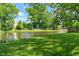 Scenic view of the tranquil pond surrounded by lush greenery, offering a peaceful and picturesque backdrop at 24 Cinnamon Ct, Brownsburg, IN 46112