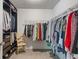 Spacious walk-in closet with ample shelving, hanging rods, and a comfortable chair at 24 Cinnamon Ct, Brownsburg, IN 46112