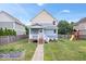 Charming two-story home featuring a spacious backyard with a playset and garden beds at 2448 Broadway St, Indianapolis, IN 46205