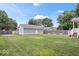 Expansive backyard with a well-maintained lawn, wooden fence, and garden beds at 2448 Broadway St, Indianapolis, IN 46205