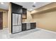A basement bar area features a stainless refrigerator, sink, and dark cabinets at 2448 Broadway St, Indianapolis, IN 46205