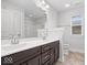 Bright bathroom featuring a double sink vanity with dark cabinets and chrome fixtures at 2448 Broadway St, Indianapolis, IN 46205