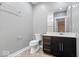Bathroom featuring a dark vanity with a light countertop, framed mirror, and toilet at 2448 Broadway St, Indianapolis, IN 46205