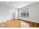 Bright bedroom with hardwood floors and a large window providing ample natural light at 2448 Broadway St, Indianapolis, IN 46205