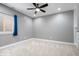 Bedroom with gray walls, ceiling fan, window with blinds and blue curtain, and neutral carpeting at 2448 Broadway St, Indianapolis, IN 46205