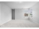 Spacious bedroom with neutral carpet, two windows, and white trim at 2448 Broadway St, Indianapolis, IN 46205