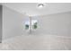 Bright bedroom with neutral carpet, two windows, and white trim at 2448 Broadway St, Indianapolis, IN 46205