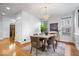 Dining area with a chandelier, table, six chairs and rug with natural light from two windows at 2448 Broadway St, Indianapolis, IN 46205