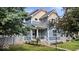 Charming two-story home featuring blue siding and a well-maintained lawn and landscaped garden at 2448 Broadway St, Indianapolis, IN 46205